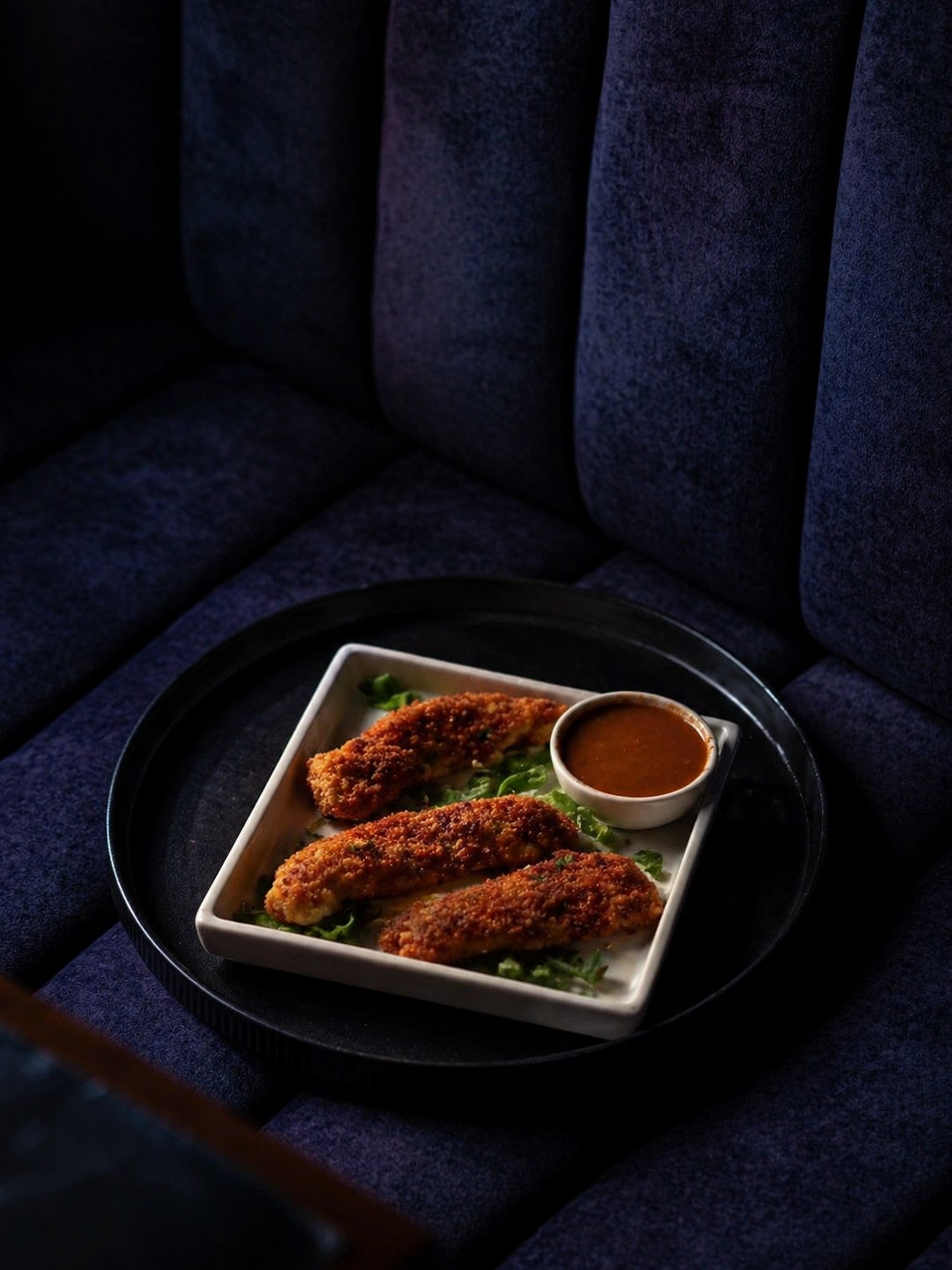 Chicken tenders on blue velvet banquette