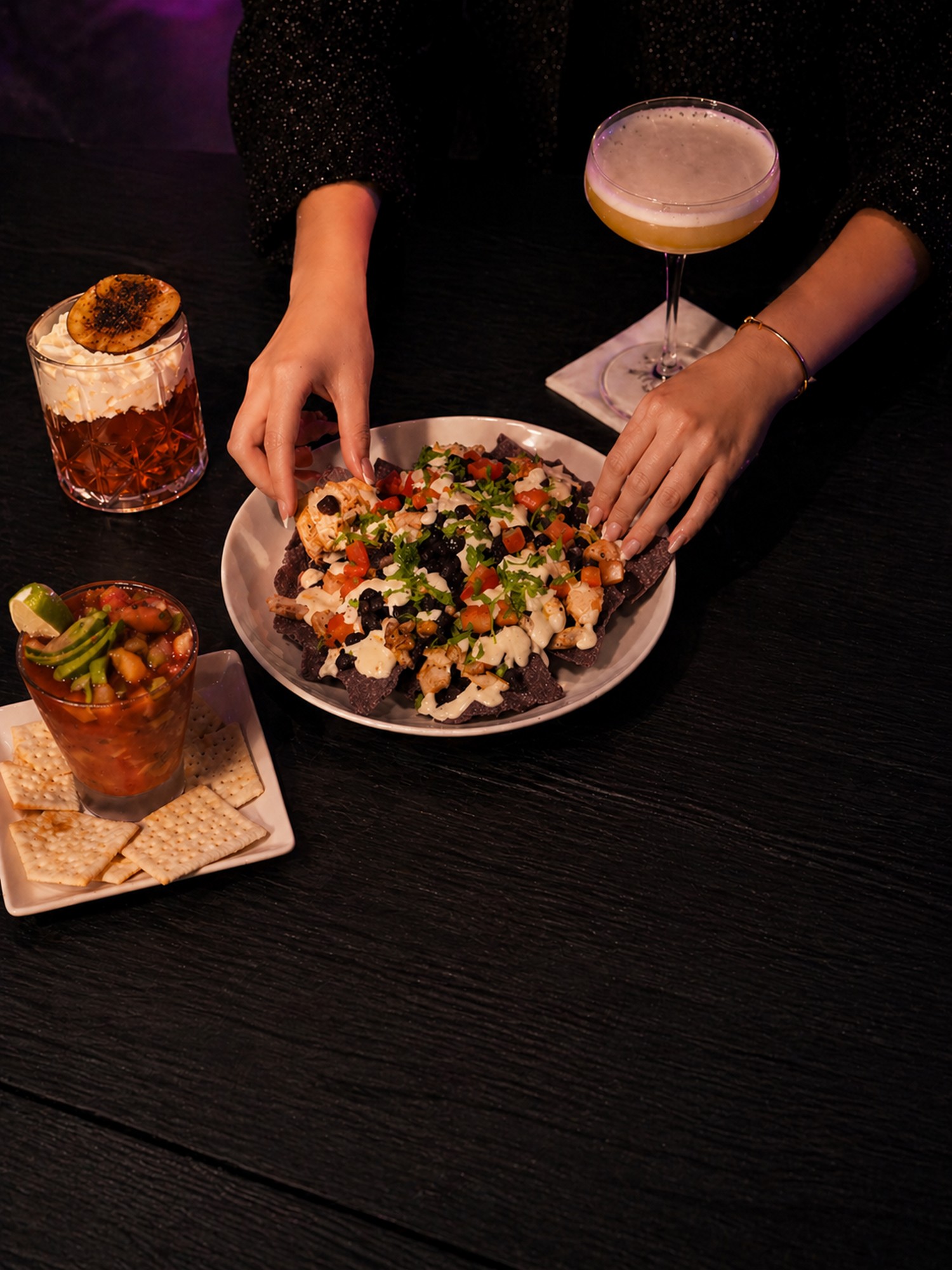 Loaded nachos with cocktails on the side