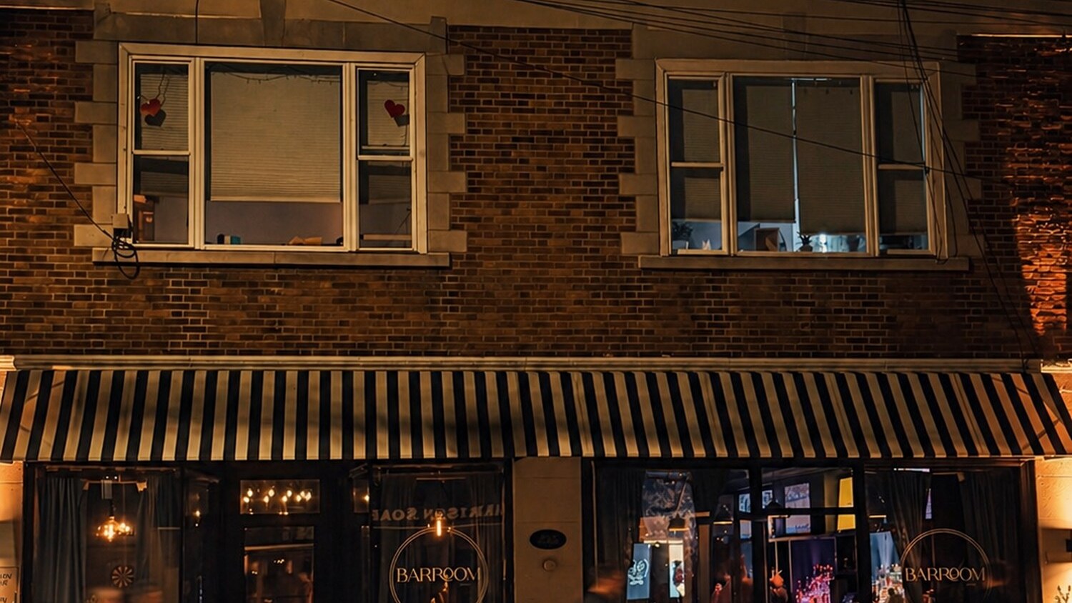 BARROOM storefront on Harrison Avenue at night, awning lit and guests at the door