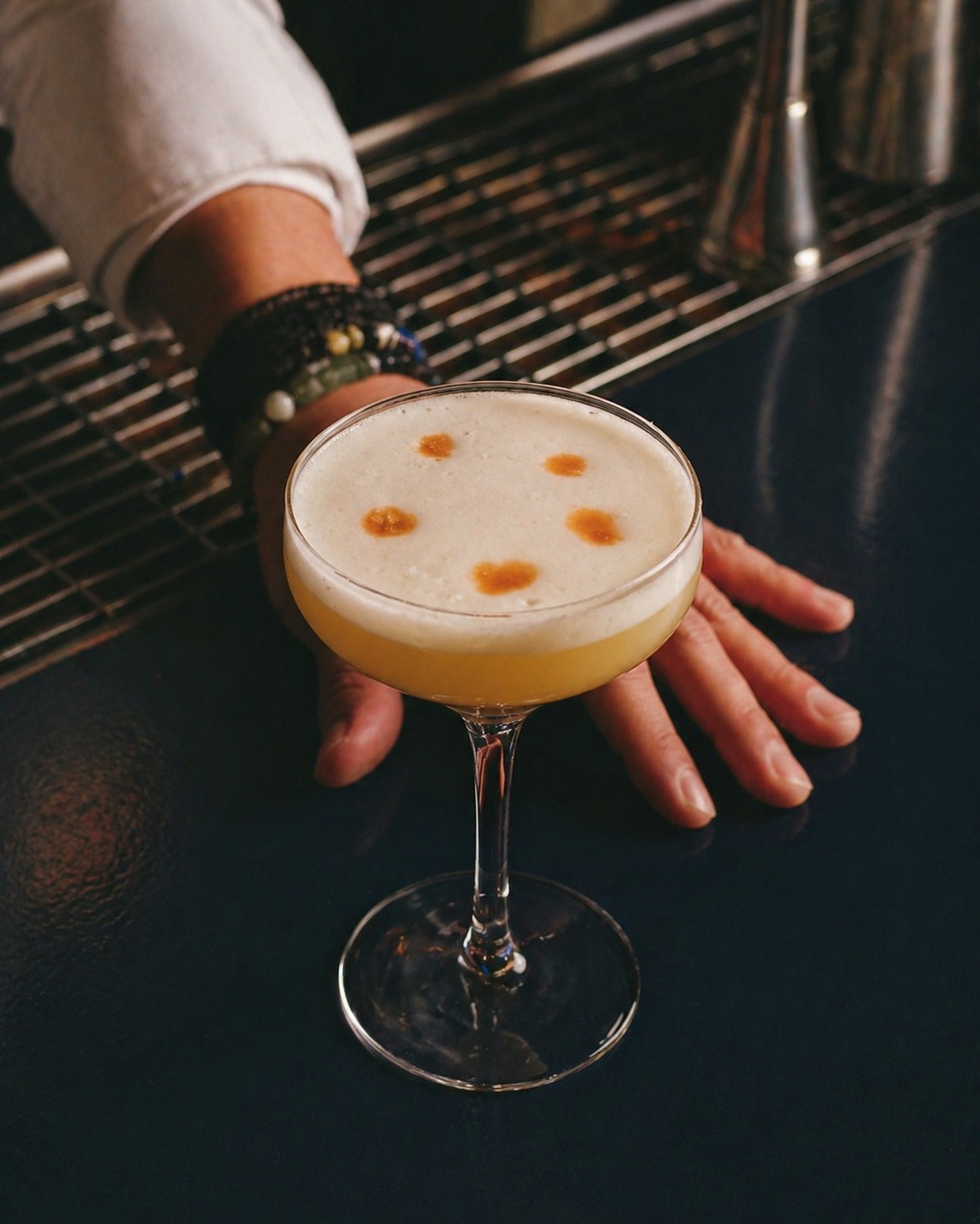 Whiskey sour with foam and bitters drops served at BARROOM